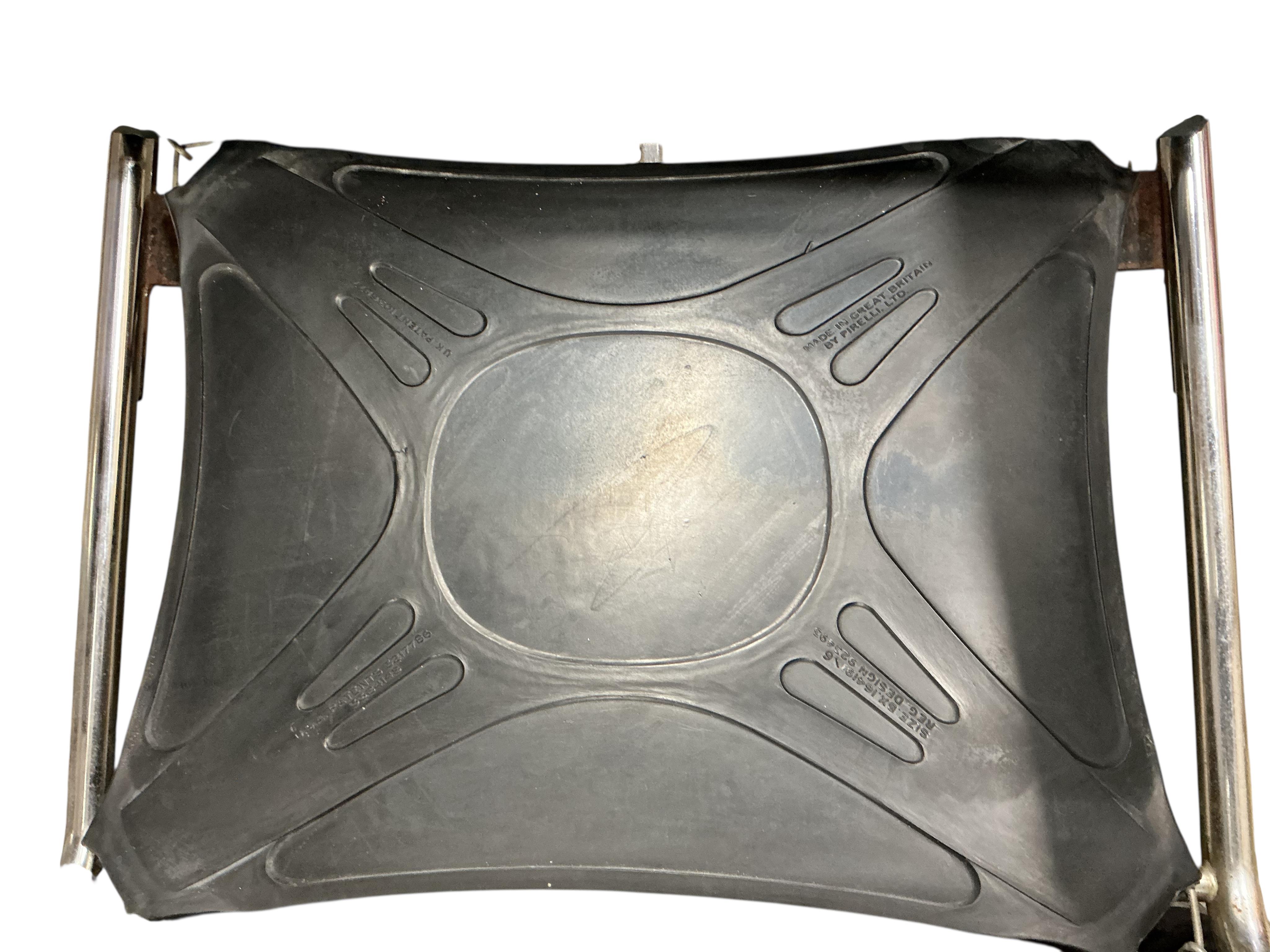 A near pair of mid century Pieff black and green leather swivel lounge chairs on chrome five prong bases, width 86cm, depth 94cm, height 91cm, one with a footstool